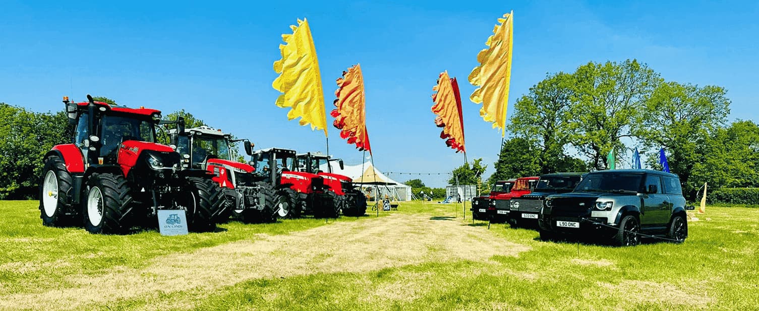 Tractors and cars in a field